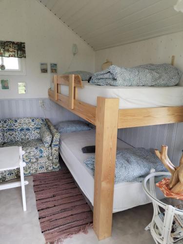 a room with two bunk beds and a table at The little cottage in Saltvik