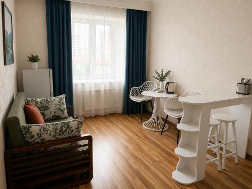 a living room with a white table and chairs at Evergreen Hotel in Ulaanbaatar