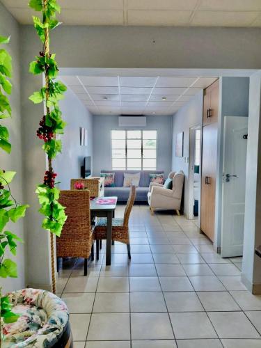 a living room with a table and chairs at The Protea & Vine - Paarl - Self Catering Apartment in Paarl