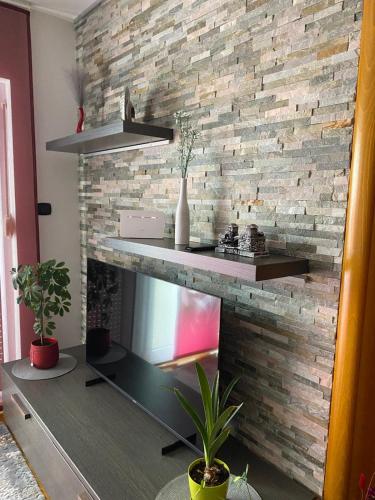 a brick wall with shelves and a fireplace at H&T in Senj