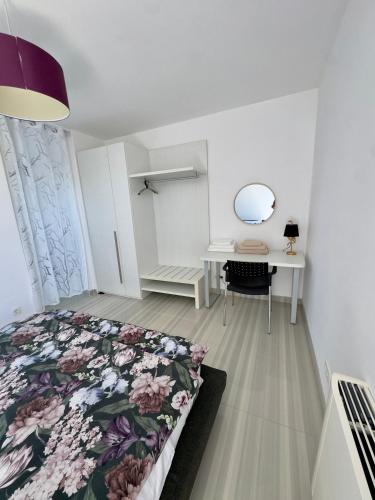 a bedroom with a bed and a desk with a mirror at St.Barth Apartments in Šibenik