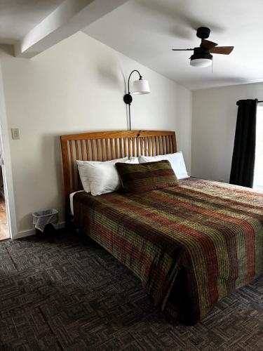 a bedroom with a bed and a ceiling fan at Killington/ Rutland 2 bedroom Cabin, cabin #4 in Killington