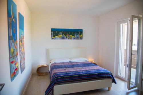 a bedroom with a bed in a room with a window at Umbra Living in Bastia Umbra