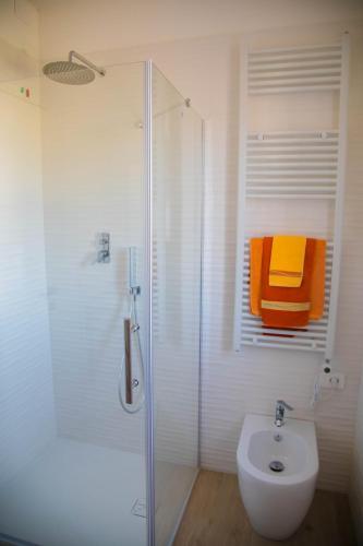 a bathroom with a shower and a toilet and a sink at Umbra Living in Bastia Umbra