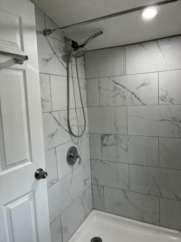 a bathroom with a shower with white marble tiles at Killington/ Rutland 2 bedroom Cabin, cabin #4 in Killington