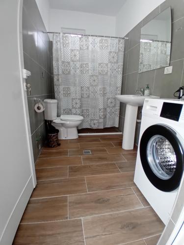 a bathroom with a washing machine and a toilet at Panorama Palace 1 in Palasë