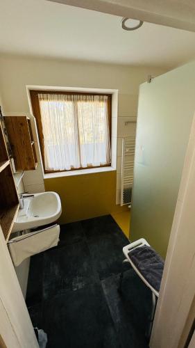 a bathroom with a toilet and a sink and a window at Ferienhaus Ma-inz in Stadl an der Mur