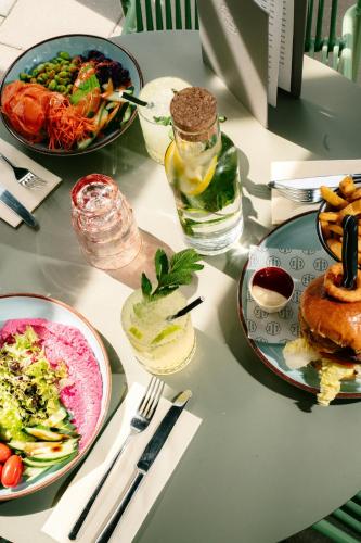 a table with plates of food on a table at The Social Hub Eindhoven in Eindhoven