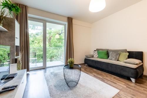 a living room with a couch and a table at Nova City Apartments in Budapest