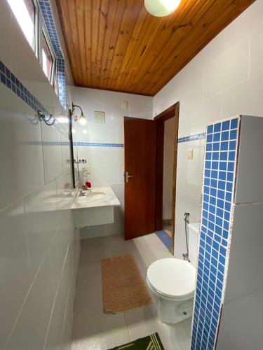 a bathroom with a toilet and a sink and a mirror at Pousada Serra Morena in Serra do Cipo