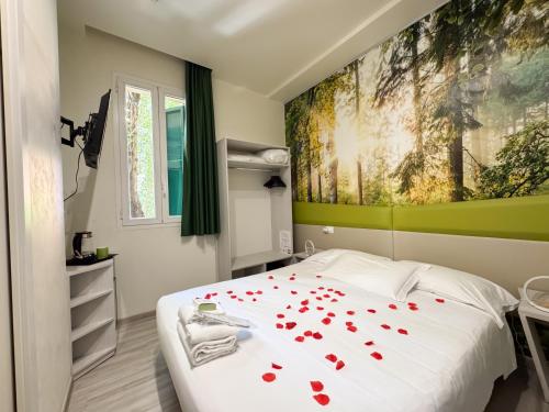 a bedroom with a bed with red hearts on it at Hotel Giardinetto Al Sant'Orsola in Bologna