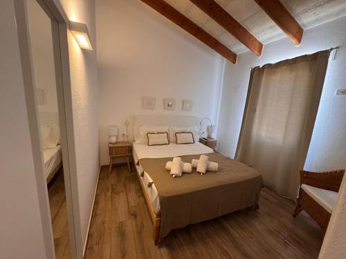 a bedroom with a bed with two towels on it at Villa Audrey in Cala en Bosc