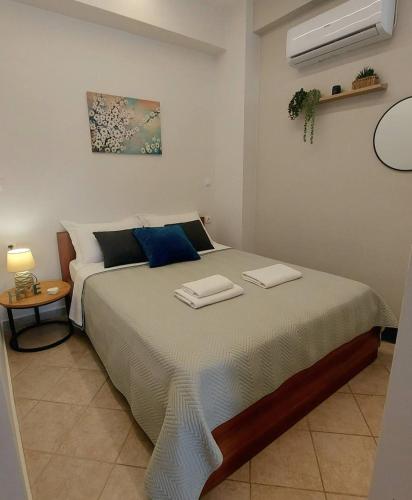 a bedroom with a large bed with two towels on it at Galazio suites 2 Seaside in Salamina