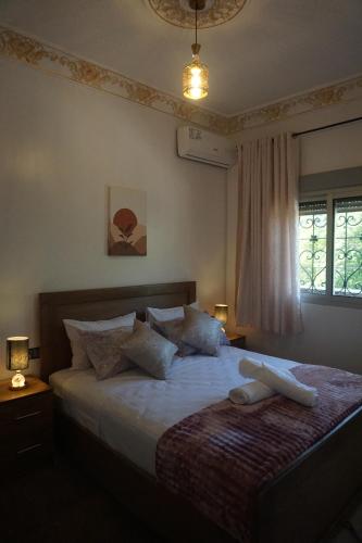 a bedroom with a large bed with pillows at Bab Akchour in Chefchaouen