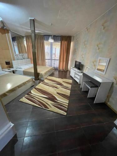 a large room with a bed and a desk at Apatcomplex Diva &restaurant&bar in Saints Constantine and Helena