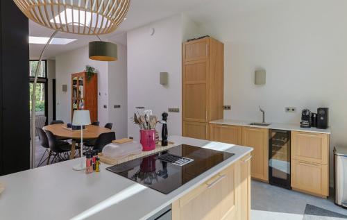 a kitchen with a white counter top and a table at De Rode Vos - Enjoyment in the forest in Giethmen