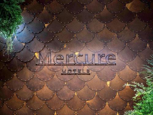 a sign that is on the side of a building at Mercure La Roche Sur Yon in La Roche-sur-Yon