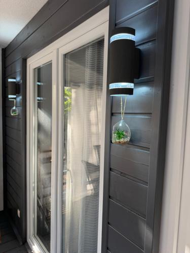 a sliding glass door with a window in a house at Holiday Home Orsag in Drage