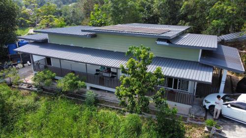 a house with solar panels on top of it at Homestay House - Tamparuli in Tamparuli
