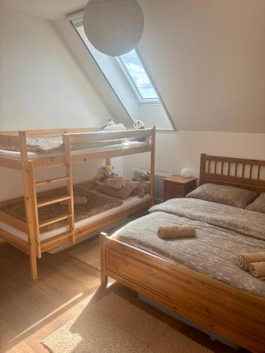 a bedroom with two bunk beds and a window at Králíkárna in Králíky