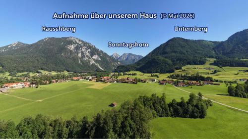 a green field with mountains in the background at Am Badezentrum Ferienwohnungen in Ruhpolding