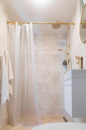 a bathroom with a shower with a shower curtain at Rupica 5 in Stara Novalja