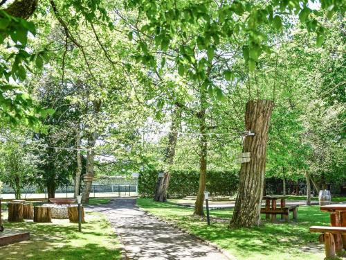 a path in a park with benches and trees at Hotel Mercure Château de Fontainebleau in Fontainebleau
