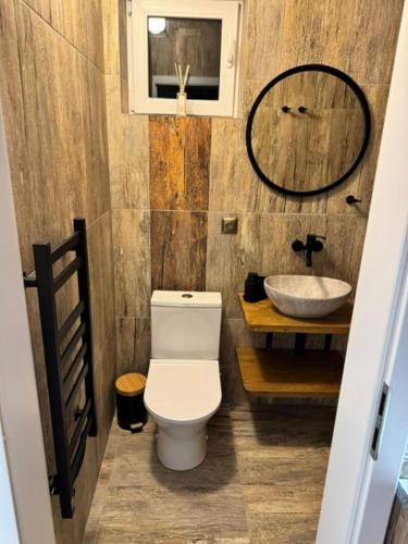 a bathroom with a toilet and a sink at Chata Biela Stopa in Tatranská Lomnica