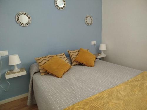 a bedroom with a bed with two clocks on the wall at MAR Y PLAYA in A Guarda
