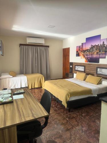 a hotel room with two beds and a table at Austral Hotel in Dos de Mayo