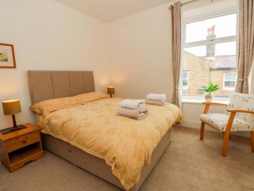 a bedroom with a bed with towels on it at 163 Manchester Road in Accrington
