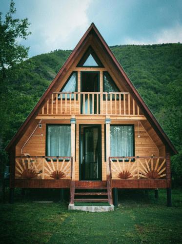 a wooden house with a porch and a deck at Lakarido in Tsesi