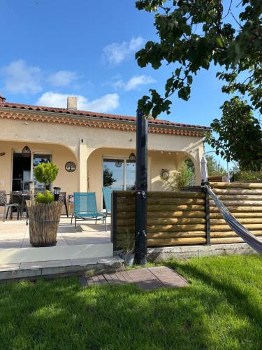 a house with a fence and a blue chair at la casa bella vista in Enval