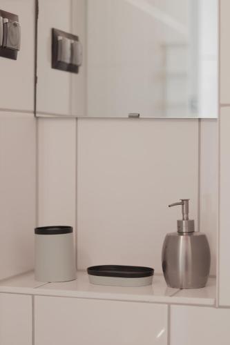 a white kitchen with a sink and a counter top at Hostel in Böhlen