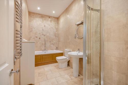 a bathroom with a toilet and a sink and a shower at 2 Bed in Beadnell oc-4641 in Beadnell