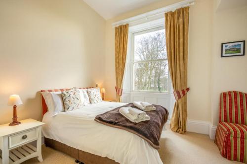 a bedroom with a bed and a window at 2 Bed in Beadnell oc-4641 in Beadnell