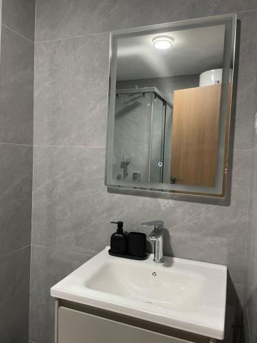 a bathroom with a white sink and a mirror at Bluvera in Šušanj