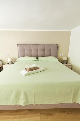 a bedroom with a large bed with a pink headboard at Mediterraneum - Loft in Sannicola