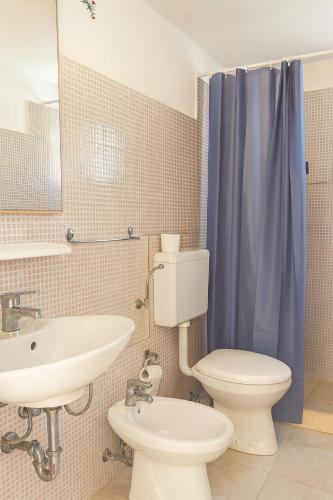 a bathroom with a sink and a toilet and a mirror at Mediterraneum - Loft in Sannicola