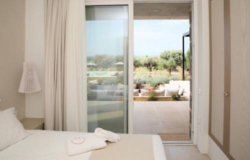 a bedroom with a bed and a view of a patio at Villa Zeno in Tragána