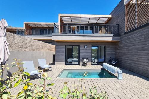 a house with a swimming pool in the backyard at Luxurious Duplex With Pool Garden Balcony in Lecci