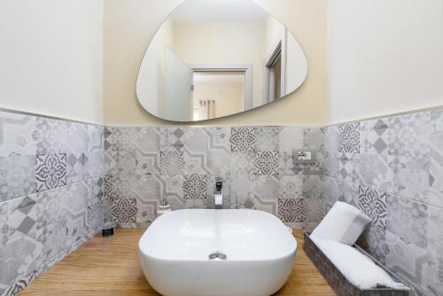 a bathroom with a white sink and a mirror at Ciabot delle Aie - Barolo in Barolo