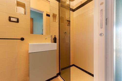 a bathroom with a sink and a mirror at Lake Suite in Miasino