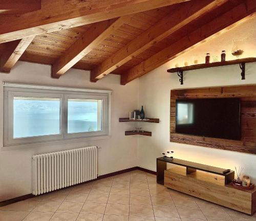 a living room with a flat screen tv on the wall at Mansarda Spadone in Musso