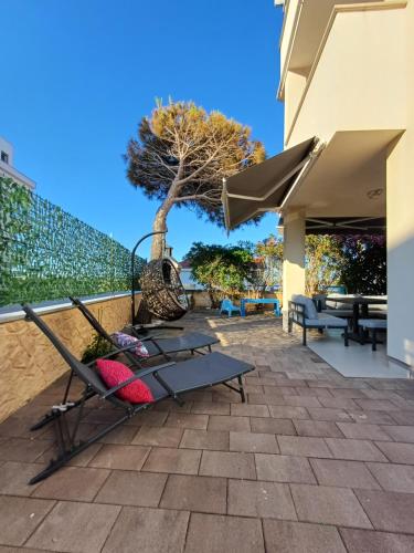 a patio with a table and chairs and a tree at Apartment BruVana in Povljana