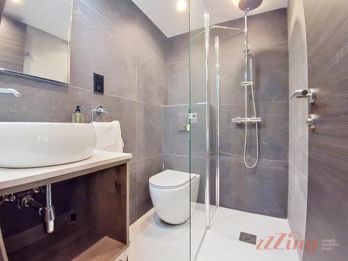 a bathroom with a shower and a toilet and a sink at A Plus Hotel St Julians - Adults Only in St. Julianʼs