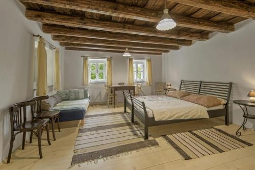 a bedroom with a bed and a couch and a table at Gallery loft Myjava Hrachoviste in Hrachovište
