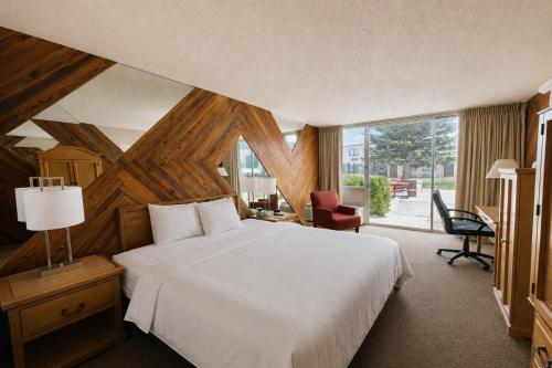 a bedroom with a white bed and a large window at Motel 6 Rawlins, WY in Rawlins