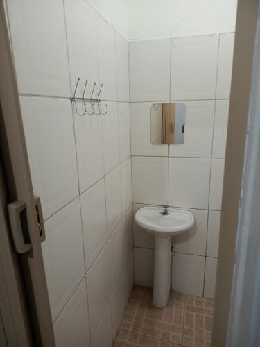 a small bathroom with a toilet and a sink at Hotel e Galeria Vizza in Goiânia