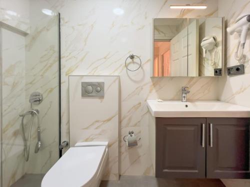 a bathroom with a shower and a sink and a mirror at Moonshine Hotel Suites in Bodrum City